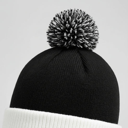 Black beanie with a gray pom-pom on a white background