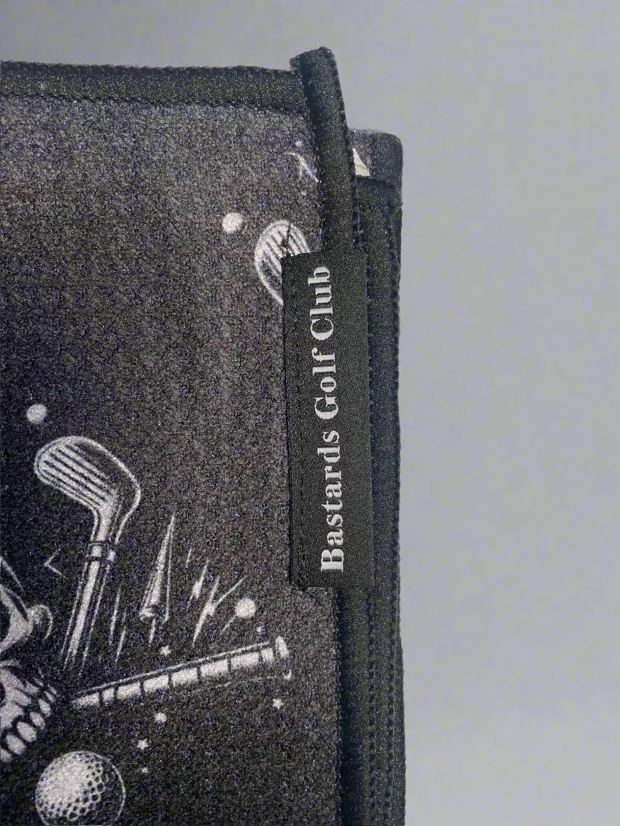 Golf towel with 'Bastards Golf Club' branding on a light gray background