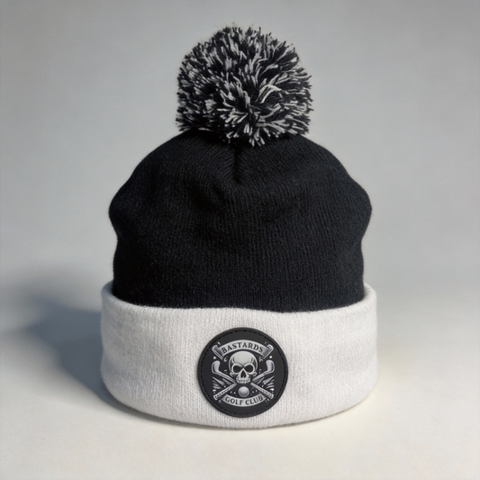 Two-tone beanie with pom-pom on a light gray background
