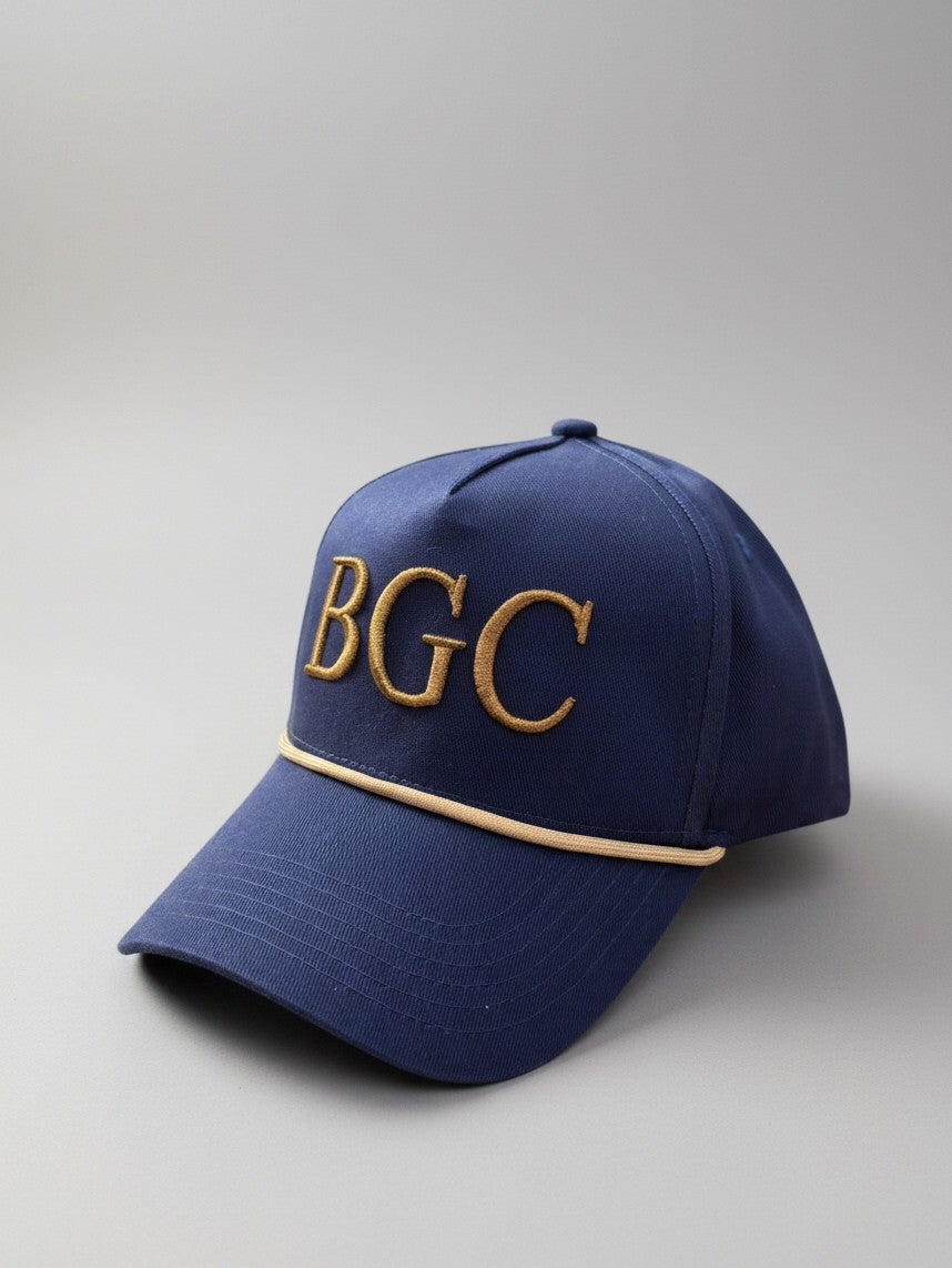 Three-quarter front view of The Major navy golf rope cap showing gold BGC embroidery and braided rope